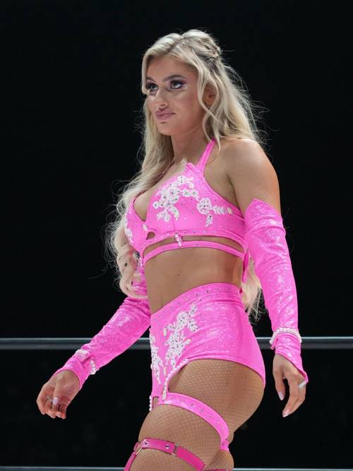 Superluchas - Una mujer vestida de rosa parada en un ring de lucha libre, Mariah May, reflexionando sobre su transición del STARDOM a AEW.