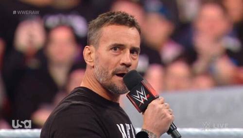 Superluchas - Un hombre sostiene un micrófono mientras se dirige a la multitud durante un evento de WWE RAW el 11 de diciembre de 2023.