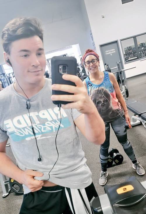 Superluchas - Veda Scott y Mike Bailey tomándose una selfie en un gimnasio.